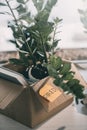 Cardboard box with books plant and sticky note with word fired