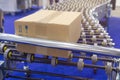 Cardboard box on conveyor belt Royalty Free Stock Photo