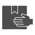 Cardboard box delivering hand holding solid icon, delivery and logistics symbol, Hand carrying package vector sign on Royalty Free Stock Photo