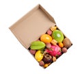 Cardboard box with different exotic fruits on white background, top view Royalty Free Stock Photo