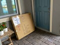 A cardboard box on the doorstep of a home Royalty Free Stock Photo