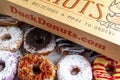 A cardboard box of a dozen donuts bought from the chain store Duck Donuts