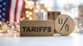 Cardboard box labeled tariffs in front of American flag Royalty Free Stock Photo