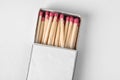 Cardboard box with matches on light background, top view. Royalty Free Stock Photo