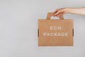 Cardboard box from natural recyclable materials in woman hand. Responsible consumption, eco friendly packaging, zero waste