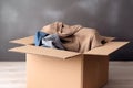 Cardboard box with old clothes for recycling and donating. Used clothes for sale, recycle or donation. AI generated
