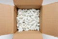 A cardboard box with packing foam pellets Royalty Free Stock Photo