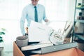 Cardboard box and resignation letter, dossier, alam clock, coffee cup, calculator and drawing tube in box. Quiting a job, Royalty Free Stock Photo