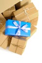 Cardboard box with several brown paper parcels and single unique christmas or birthday gift Royalty Free Stock Photo