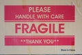 Cardboard Box side with words of warning, Please Handle with Care, Fragile, and Thank You, printed in the center with Made in Chin