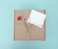 Cardboard box tied with a rope with a flower and a white blank Royalty Free Stock Photo