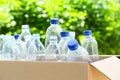 Cardboard box with used plastic bottles outdoors. Recycle concept Royalty Free Stock Photo