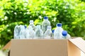 Cardboard box with used plastic bottles outdoors. Recycle concept Royalty Free Stock Photo