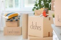 Cardboard boxes and adhesive tape dispenser indoors Royalty Free Stock Photo