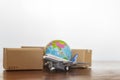 Cardboard boxes with airplane and earth globe Royalty Free Stock Photo