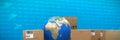 Composite image of cardboard boxes with blue globe Royalty Free Stock Photo