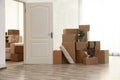 Cardboard boxes and cat in room on moving day Royalty Free Stock Photo