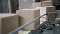 Cardboard boxes on conveyor belt in factory. Clip. Production line on which the boxes move Royalty Free Stock Photo