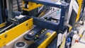 Cardboard boxes on conveyor belt in factory. Clip. Production line on which the boxes move in a spiral Royalty Free Stock Photo