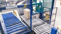Cardboard boxes on conveyor belt in factory. Clip. Production line on which the boxes move in a spiral Royalty Free Stock Photo