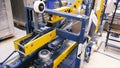 Cardboard boxes on conveyor belt in factory. Clip. Production line on which the boxes move in a spiral Royalty Free Stock Photo