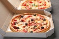 Cardboard boxes with delicious pizzas on table Royalty Free Stock Photo