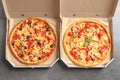 Cardboard boxes with delicious pizzas on table Royalty Free Stock Photo