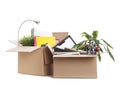 Cardboard boxes full of office stuff on white