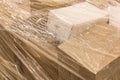 Cardboard boxes with goods or building materials and wrapped in packaging film, close-up Royalty Free Stock Photo