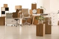 Cardboard boxes with houseplant in new office, space for text. Moving day Royalty Free Stock Photo