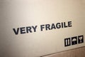 Cardboard boxes labeled very fragile. Important information. Text in the middle of the picture