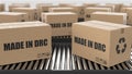 Cardboard boxes with Made in DRC text on roller conveyor