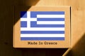 Made in Greece. Cardboard boxes with text `Made In Greece` and the Flag of Greece.