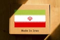 Made in Iran. Cardboard boxes with text `Made In Iran` and the Flag of Iran.