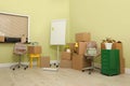 Cardboard boxes with packed stuff in office. Moving day Royalty Free Stock Photo