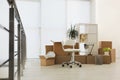Cardboard boxes with packed stuff in office. Moving day Royalty Free Stock Photo