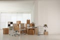 Cardboard boxes and stuff in office. Moving day Royalty Free Stock Photo