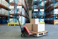 Cardboard boxes on a pallet jack in warehouse Royalty Free Stock Photo