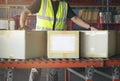 Cardboard boxes sorting on rollers conveyor belt. Worker moving boxes into storage warehouse. manufacturing warehouse. Royalty Free Stock Photo