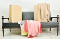 Cardboard boxes and stack of clothes on a black sofa Royalty Free Stock Photo