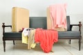 Cardboard boxes and stack of clothes on a sofa Royalty Free Stock Photo