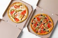 Cardboard boxes with tasty pizzas on wooden background Royalty Free Stock Photo