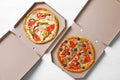 Cardboard boxes with tasty pizzas on wooden background Royalty Free Stock Photo