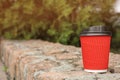Cardboard coffee cup with lid on stone surface outdoors Royalty Free Stock Photo