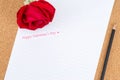 Cardboard, corkboard with note paper with pencil and rose beside