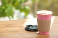 Cardboard cup of coffee on table against blurred background Royalty Free Stock Photo