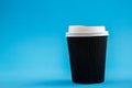 Cardboard disposable cups isolated on a blue background. Front view Royalty Free Stock Photo