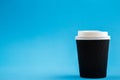 Cardboard disposable cups isolated on a blue background. Front view Royalty Free Stock Photo