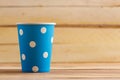 Cardboard disposable cups isolated on a wooden background. Front view Royalty Free Stock Photo