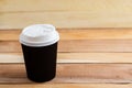 Cardboard disposable cups isolated on a wooden background. Front view Royalty Free Stock Photo